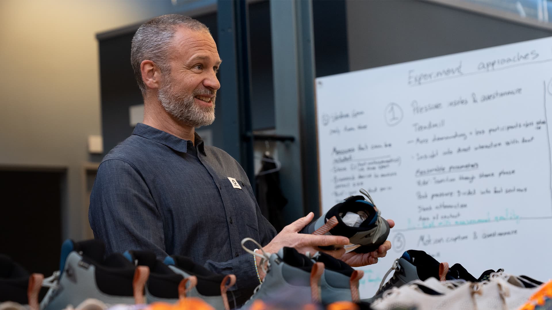 Image of David Ekelund holding a shoe and smiling