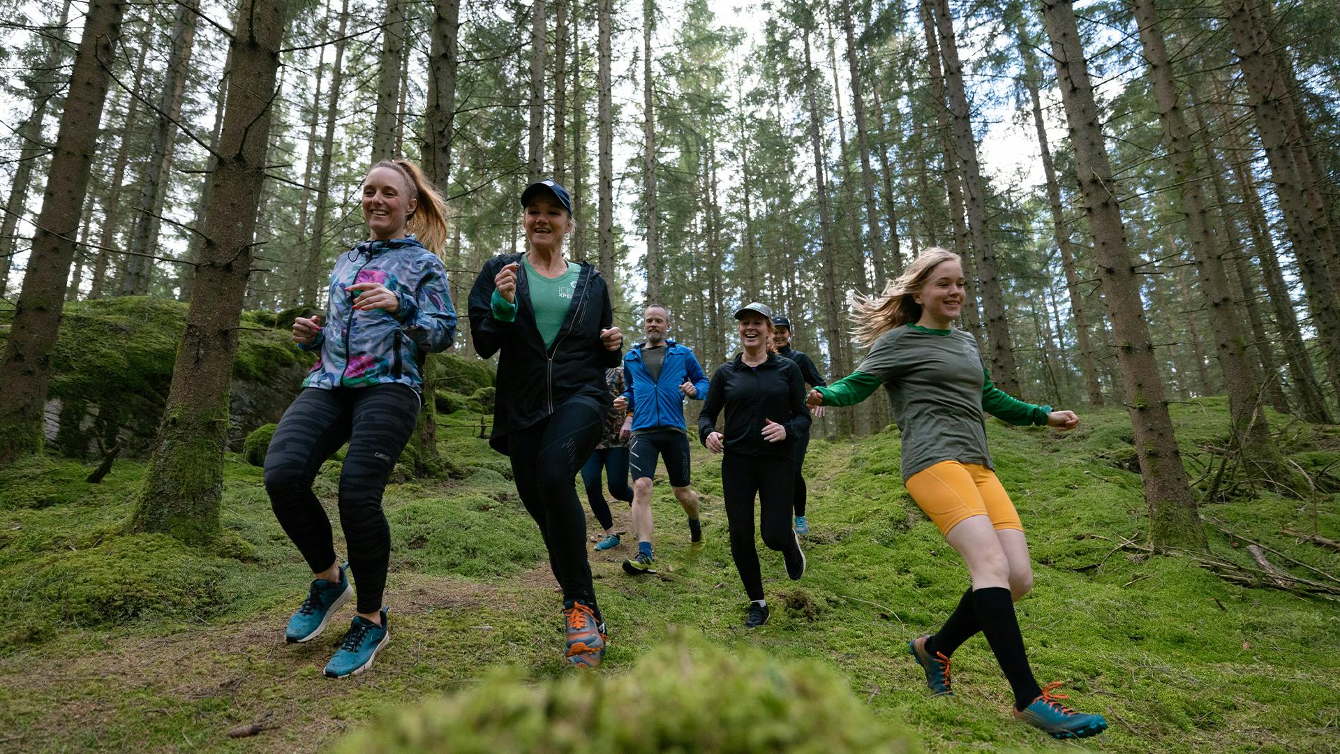 Icebug employees running downhill in the forest