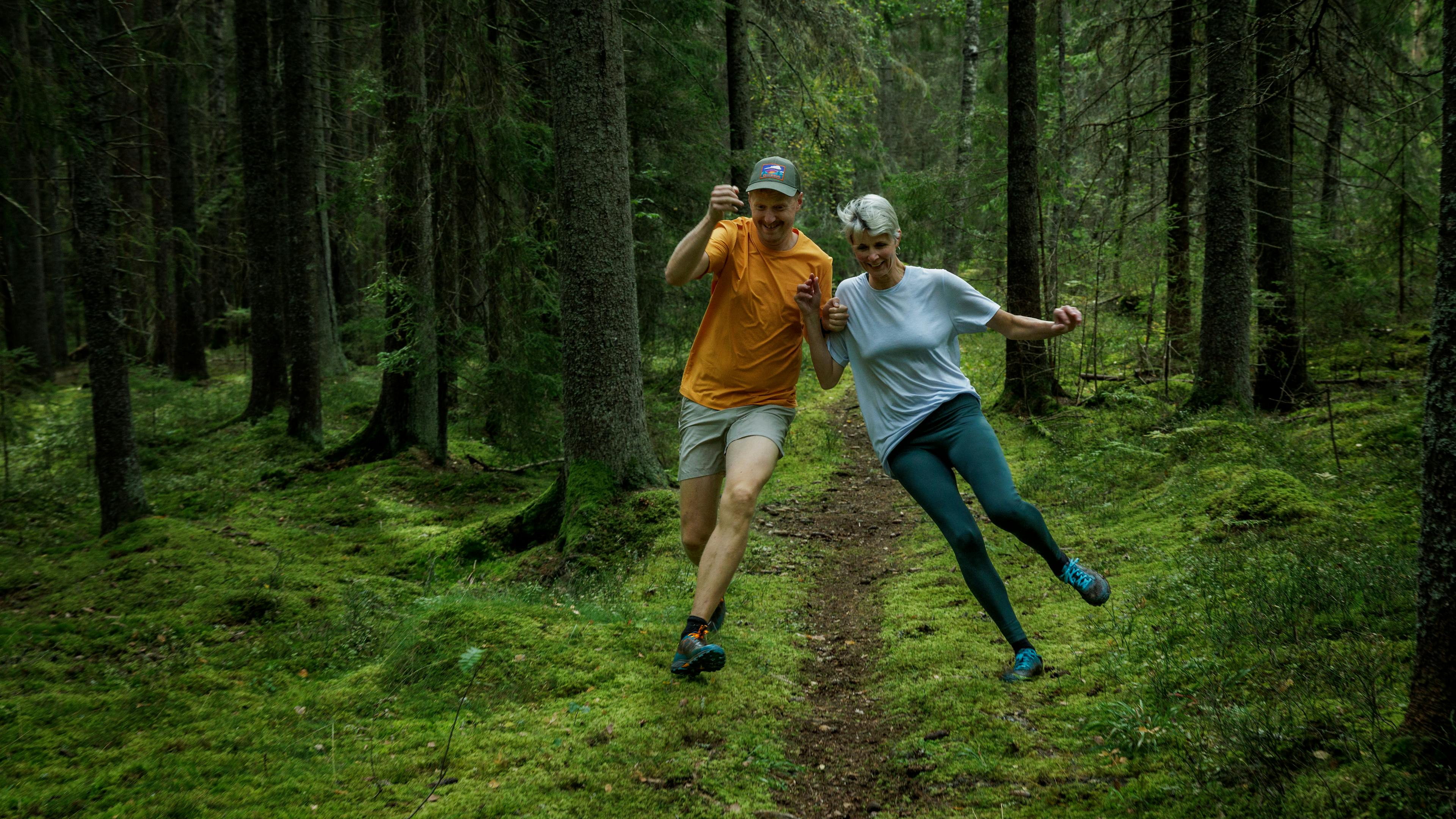 two people running down a trail in the woods wearing Icebug Pytho6 RB9X